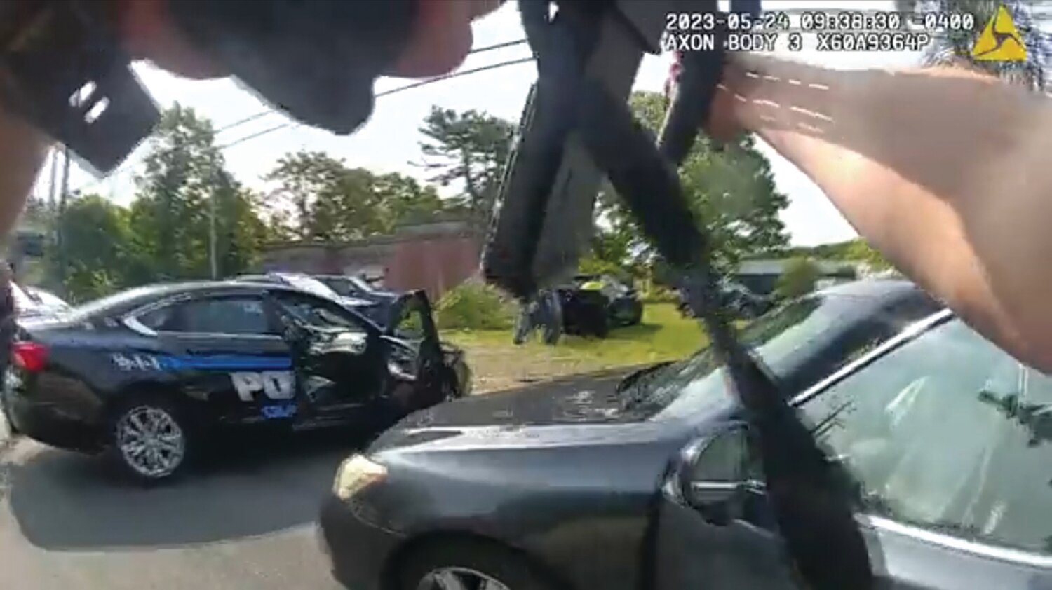 HEAVY POLICE PRESENCE: Police from multiple departments converged on a shooting suspect’s car along Plainfield Pike, on the Johnston/Cranston border, on May 24. The suspect was shot dead, and Cranston Police have now released body-worn camera footage from the deadly force incident.